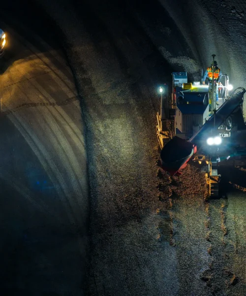 An aerial view of a concrete curb machine at night.